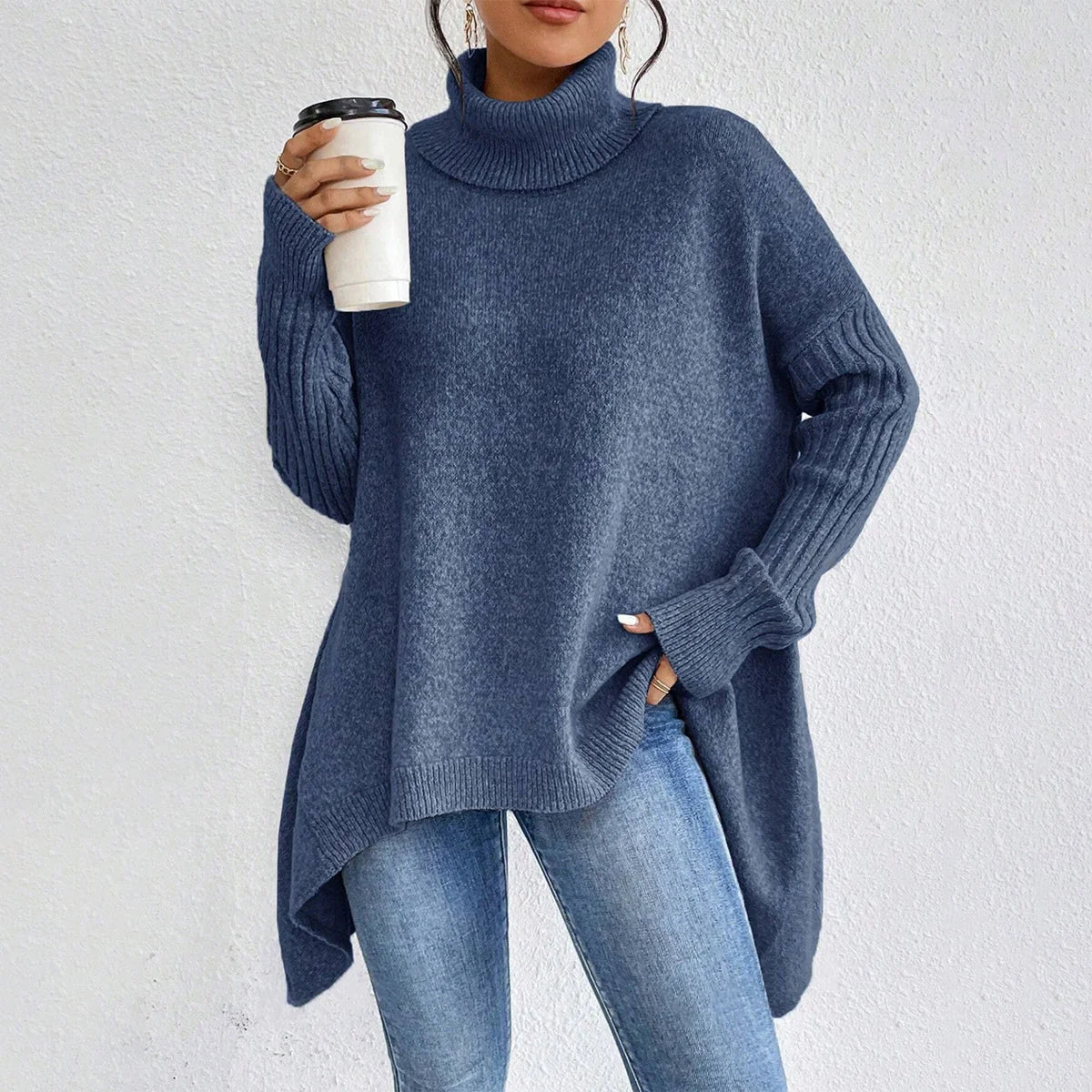 woman holding coffee wearing blue turtleneck sweater
