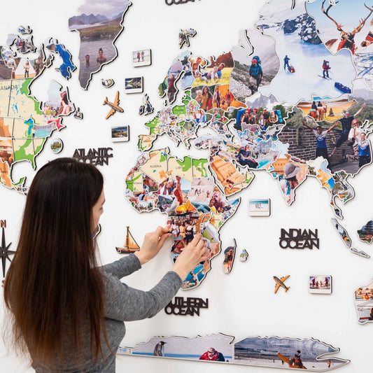 Wood world map wall art with photo frames on a living room wall