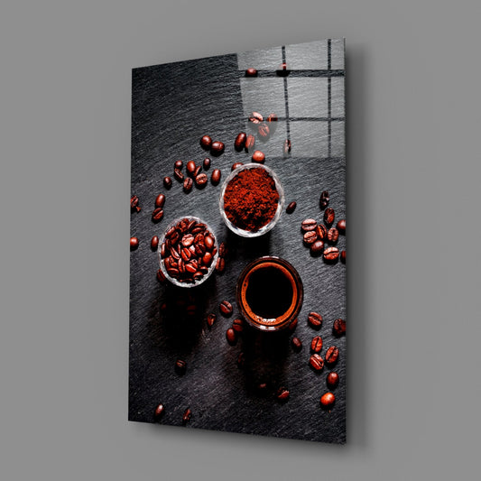 Coffee beans and espresso cups glass wall art angled against a soft gray backdrop