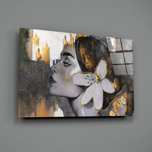 Woman with a white lily in gold and gray glass wall art on a gray wall, angled view