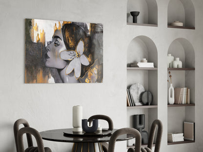 Woman with a white lily in gold and gray glass wall art above a round dining table beside arched shelves
