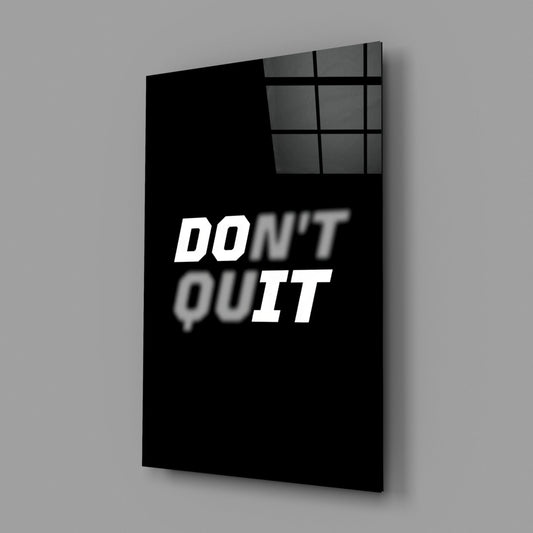 Don't Quit motivational tempered glass print angled against a gray wall
