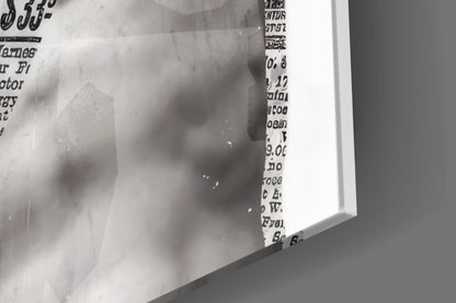 Close-up of the glossy tempered glass edge on the marble statue on yellow newsprint collage print