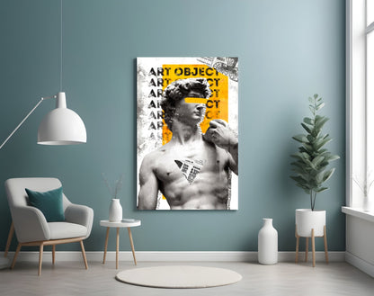 Marble statue on yellow newsprint collage glass wall art on a blue-gray wall above a white armchair and a pendant lamp