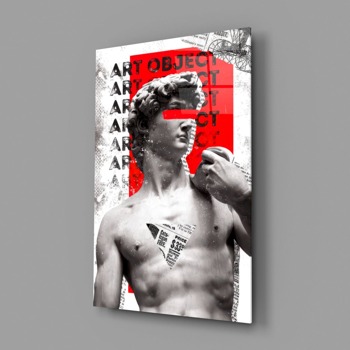 Marble statue on red newsprint collage glass wall art angled against a soft gray backdrop
