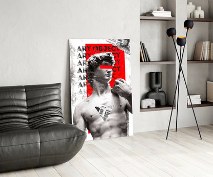 Marble statue on red newsprint collage glass wall art leaning beside a black leather lounge chair and open shelves