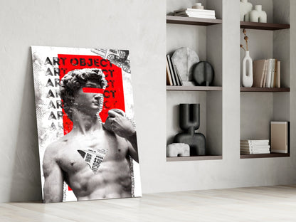 Marble statue on red newsprint collage glass wall art leaning against a white wall beside open shelves with vases