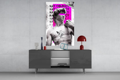 Marble statue on magenta newsprint collage glass wall art above a gray sideboard with a red table lamp on a concrete wall