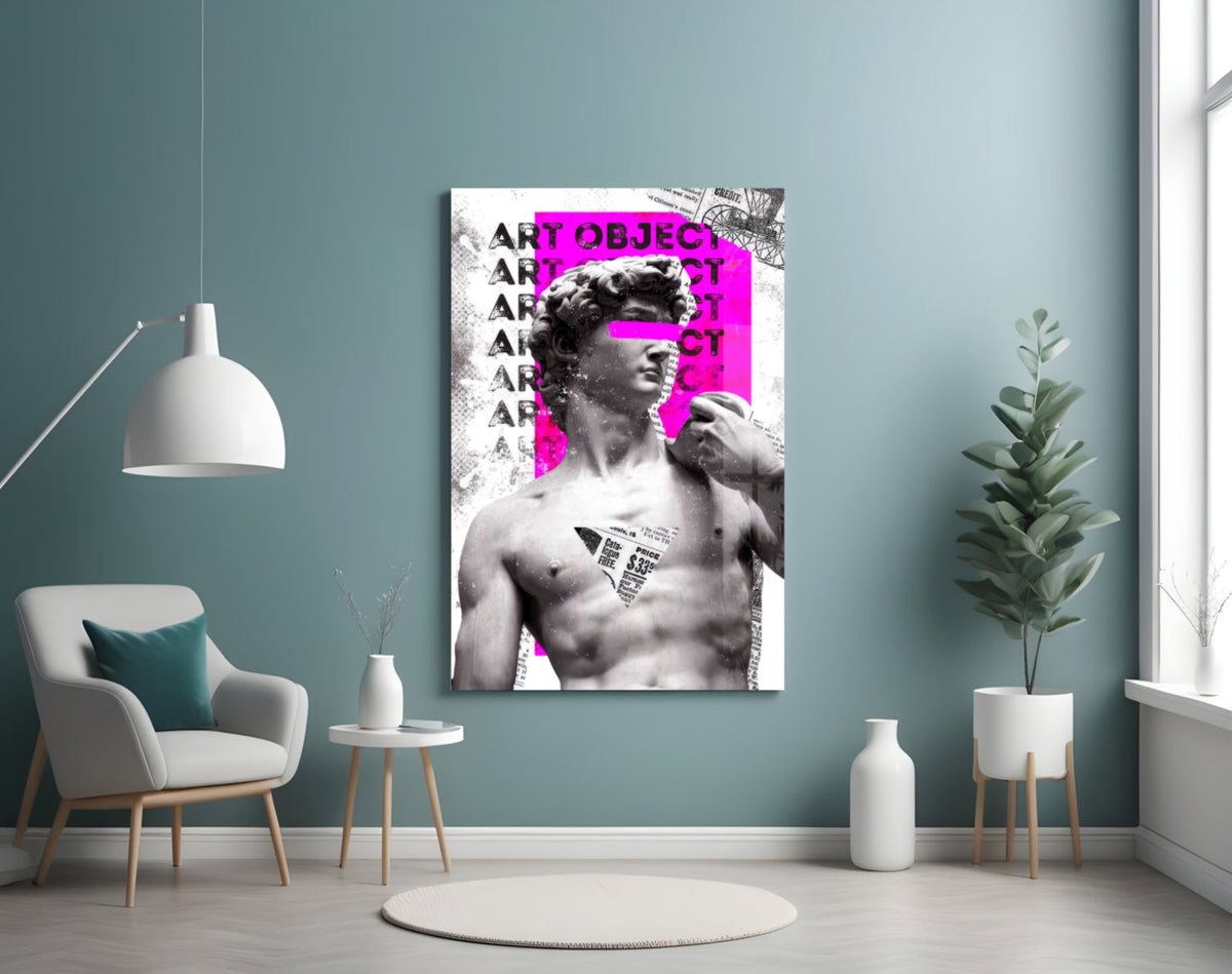 Marble statue on magenta newsprint collage glass wall art on a blue-gray wall above a white armchair and a pendant lamp