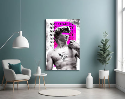 Marble statue on magenta newsprint collage glass wall art on a blue-gray wall above a white armchair and a pendant lamp