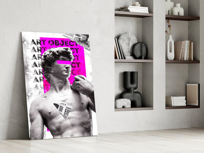 Marble statue on magenta newsprint collage glass wall art leaning against a white wall beside open shelves with vases