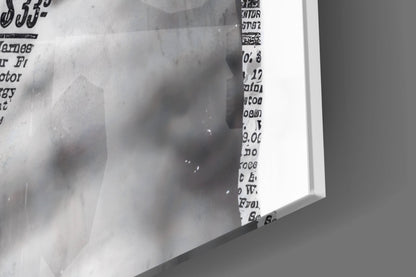 Close-up of the glossy tempered glass edge on the marble statue on blue newsprint collage print