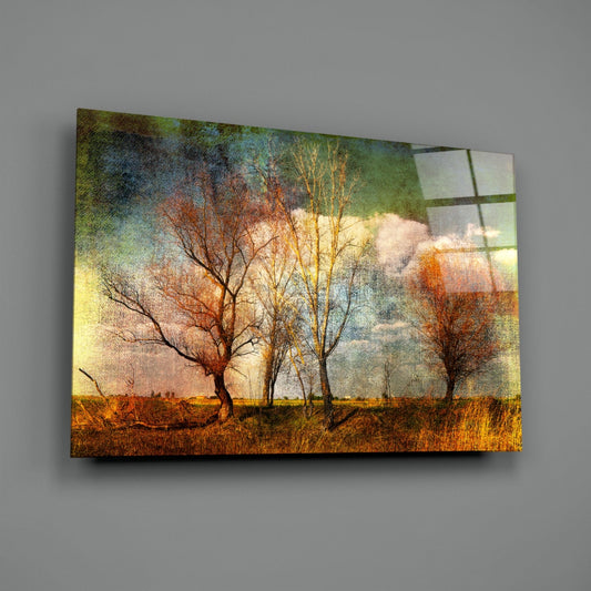 Autumn trees in a golden meadow glass wall art on a gray wall