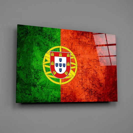 Weathered Portugal flag glass wall art on a gray wall with a window reflection on the glass