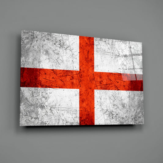 Scratched gray England flag glass wall art angled on a gray backdrop with light reflecting off the glossy front