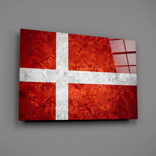 Mottled Denmark flag glass wall art on a gray wall with a window reflection across the glossy glass