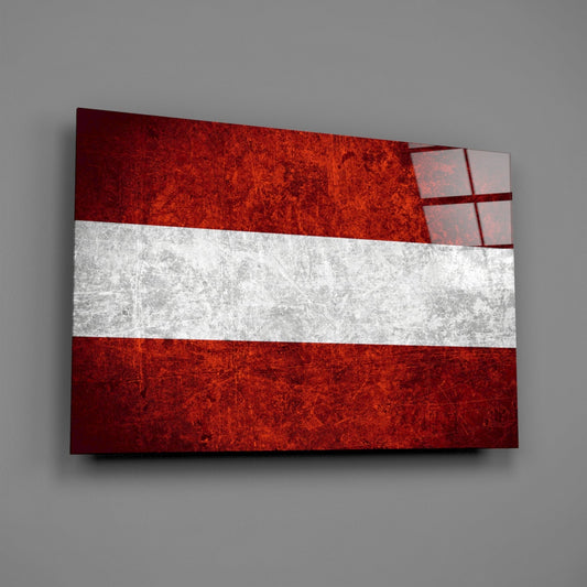 Weathered Austria flag glass wall art on a gray wall with a window reflection across the glossy glass