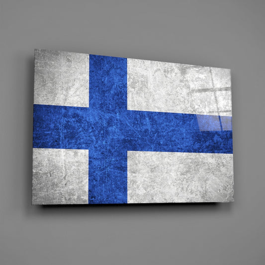 Weathered Finland flag glass wall art on a gray wall with a window reflection across the glossy glass