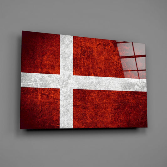 Deep red weathered Denmark flag glass wall art on a gray wall with a window reflection across the glossy glass