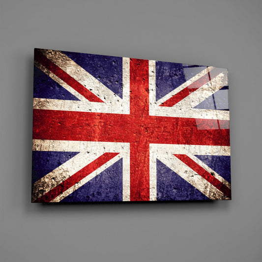 Worn stone United Kingdom flag glass wall art angled on a gray backdrop with light reflecting off the glossy front