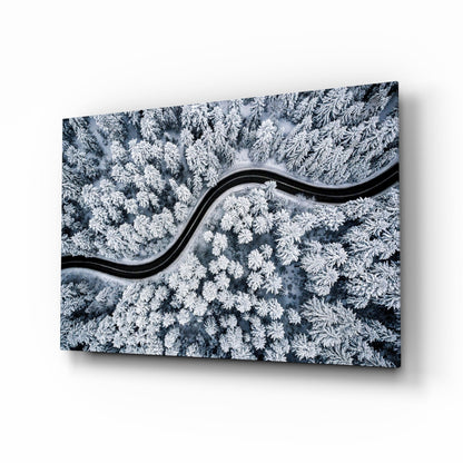 Snowy forest road aerial glass wall art
