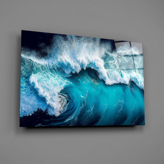 Deep blue breaking wave glass wall art on a gray wall, light reflecting off the glossy front
