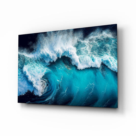 Aerial view of a curling turquoise wave with white foam across a deep blue sea, printed on glass, on a white background