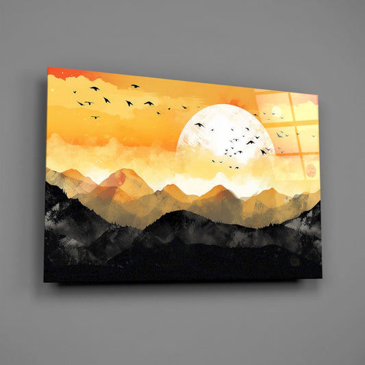 Orange sunset mountains glass wall art on a gray wall, light reflecting off the glossy front