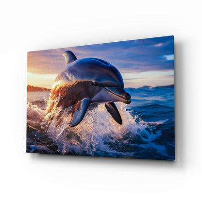 Dolphin glass wall art with a leaping dolphin at sunset