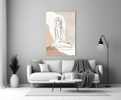 Kneeling woman line art glass wall art above a white sofa beside a black floor lamp