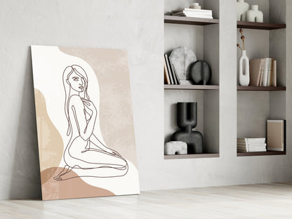 Kneeling woman line art glass print leaning against a white wall beside open shelves