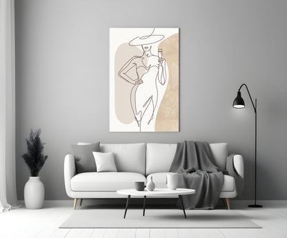 Wide hat line art woman glass wall art above a white sofa with a gray throw and a black floor lamp