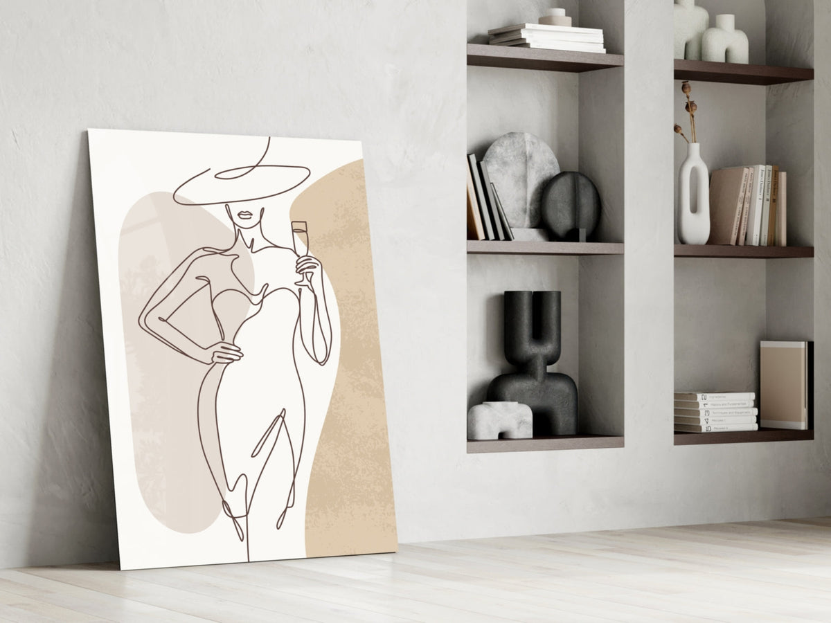 Wide hat line art woman glass wall art leaning beside built-in shelves with vases and books