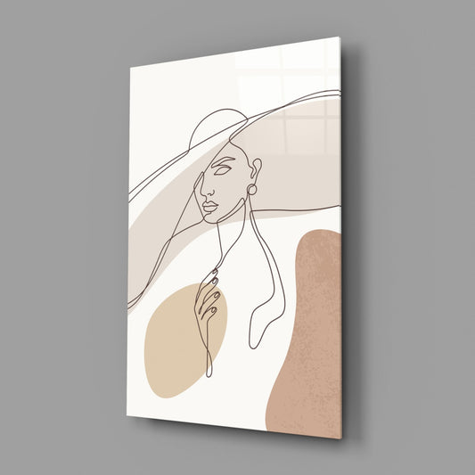 Sun hat line art woman glass wall art hanging on a plain gray wall