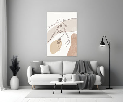 Sun hat line art woman glass wall art above a white sofa with a gray throw and a black floor lamp