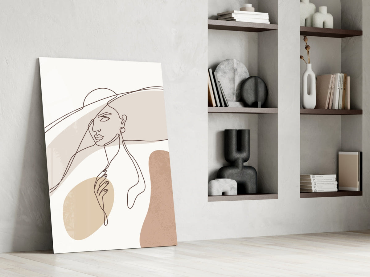 Sun hat line art woman glass wall art leaning beside built-in shelves with vases and books