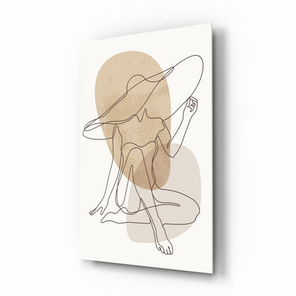 Single line drawing of a seated woman in a wide-brim hat over soft beige and blush shapes, printed on glass, angled view