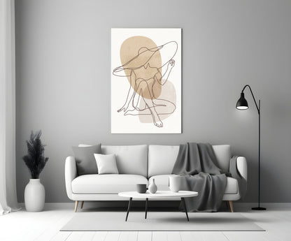 Seated woman line art glass wall art above a white sofa beside a black floor lamp