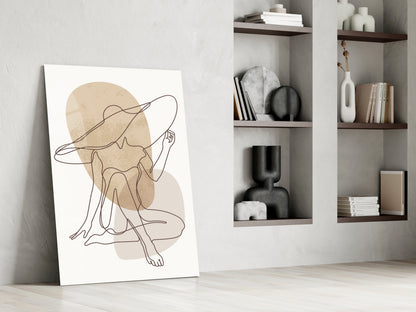 Seated woman line art glass print leaning against a white wall beside open shelves