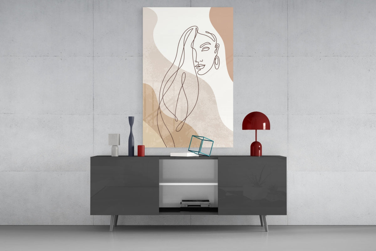 Line art woman with flowing hair glass wall art above a dark gray media console with a red table lamp
