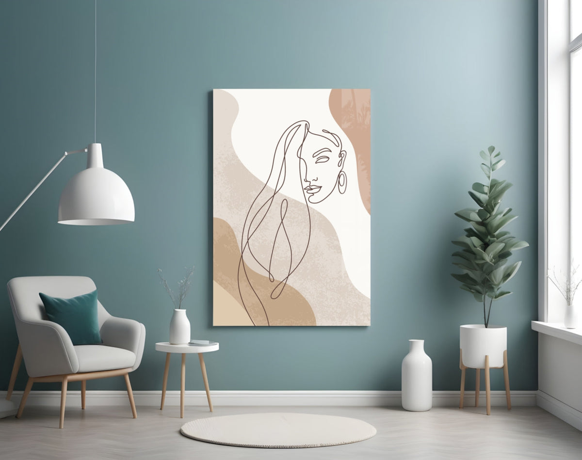 Line art woman with flowing hair glass wall art on a teal wall above a gray armchair and a white pendant lamp
