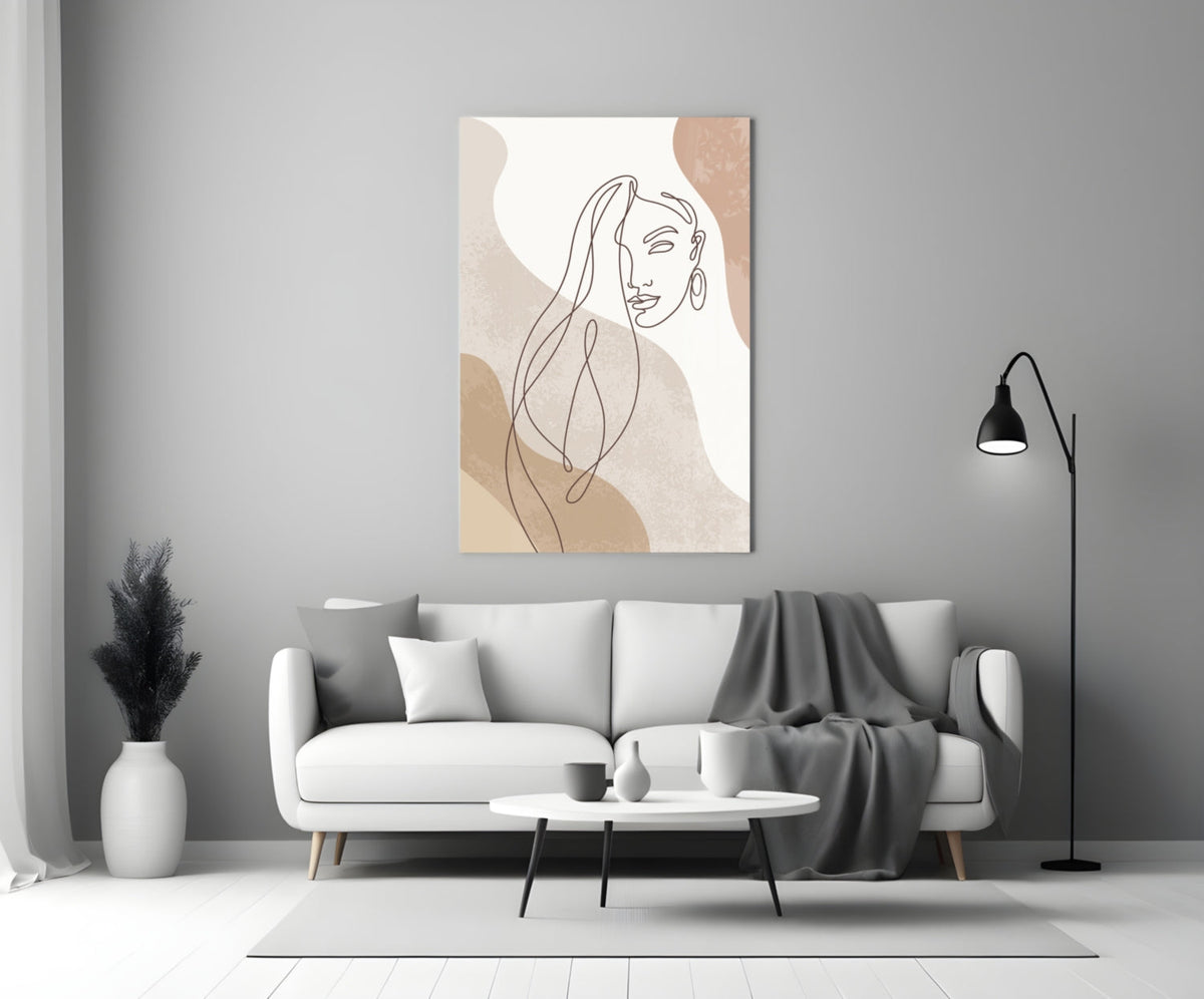 Line art woman with flowing hair glass wall art above a white sofa beside a black arc floor lamp