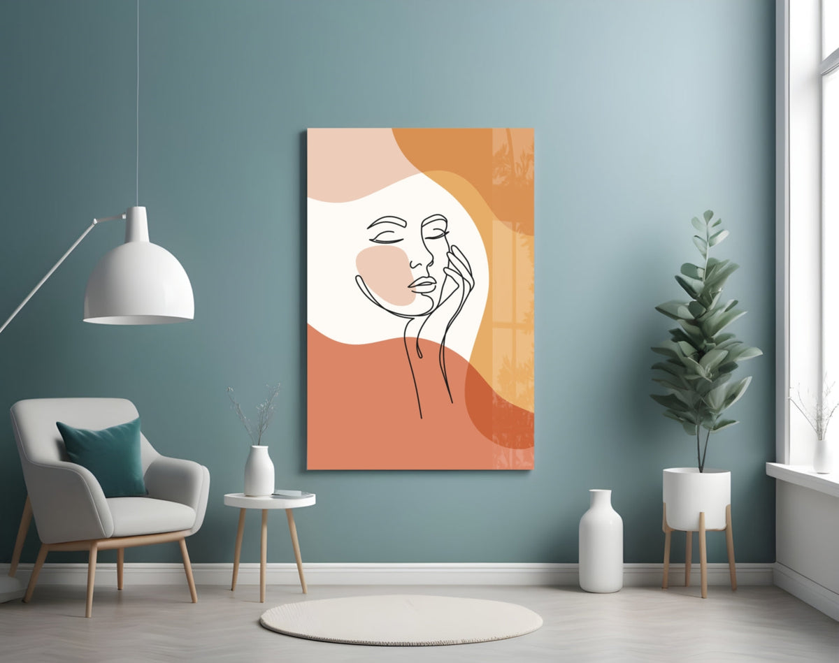 Terracotta line art face glass wall art on a blue wall above a cream armchair and pendant lamp
