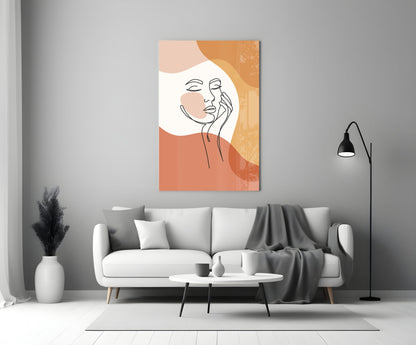 Terracotta line art face glass wall art above a white sofa beside a black floor lamp