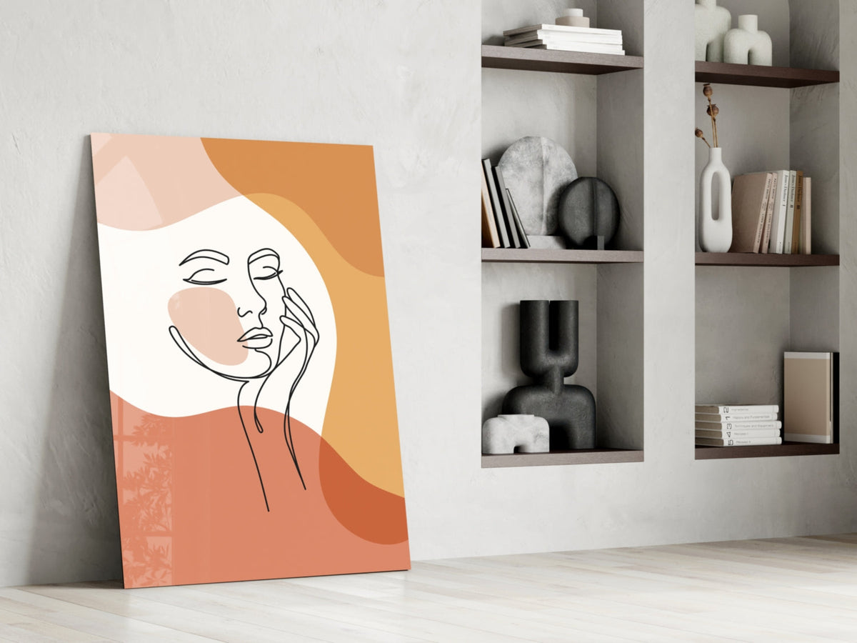 Terracotta line art face glass print leaning against a white wall beside open shelves