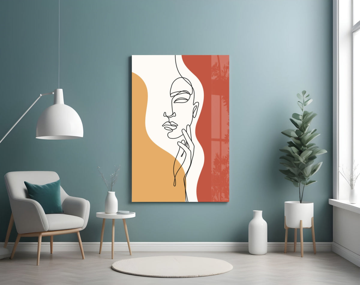 Rust line art face glass wall art on a blue wall above a cream armchair and pendant lamp
