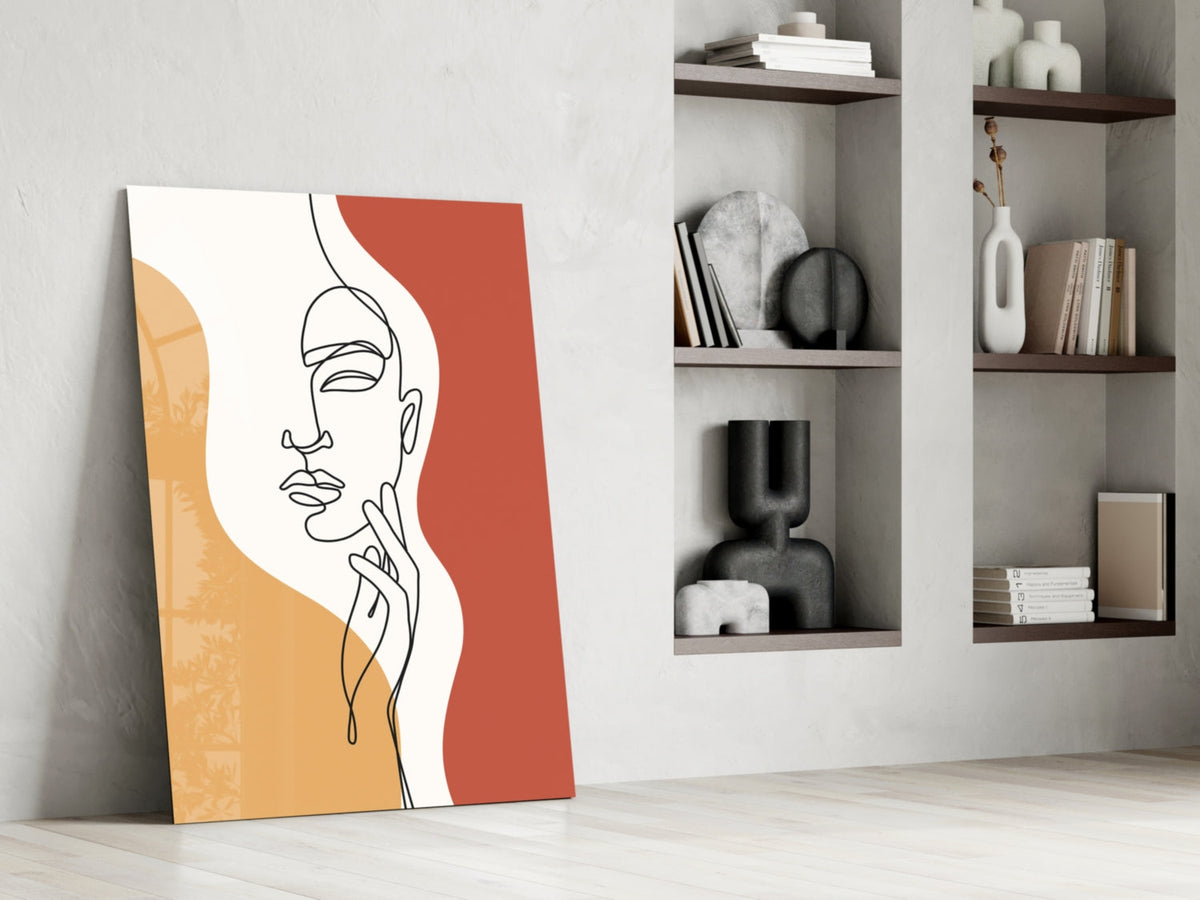 Rust line art face glass print leaning against a white wall beside open shelves