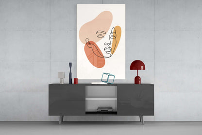Line art woman face glass wall art above a dark gray media console with a red table lamp